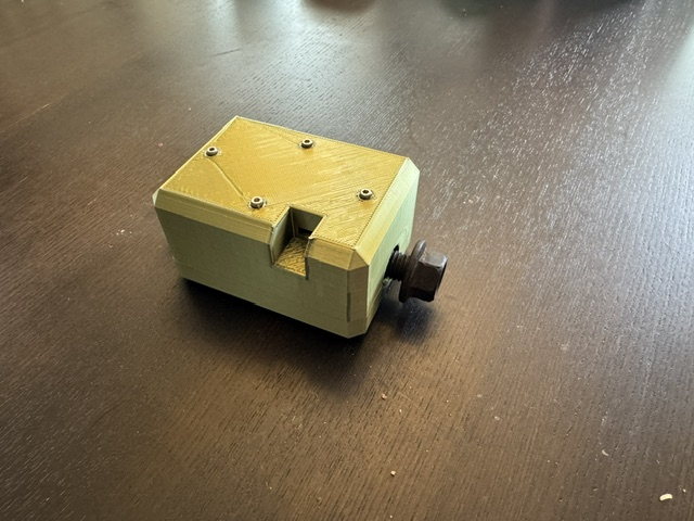 The prototype enclosure from the side: the cut-out slot in the printed housing and the knob on its threaded boss.